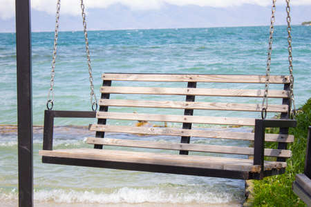 wooden carousel in the blue sea backgroundの写真素材