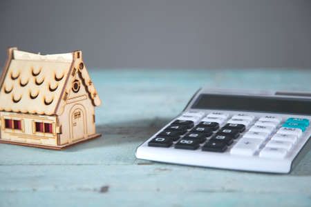 house model and calculator on the blue tableの写真素材