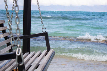 wooden carousel in the blue sea background