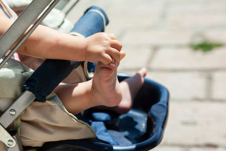 baby in a stroller in the street backgroundの写真素材