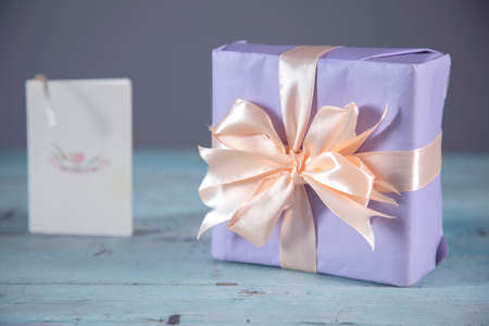 postcard with gift box on the table backgroundの写真素材