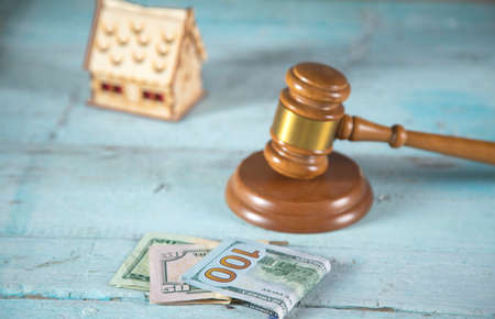house model and money with judge on the table