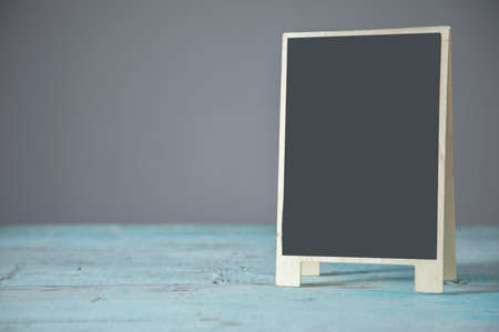 black chalkboard on the blue table backgroundの写真素材