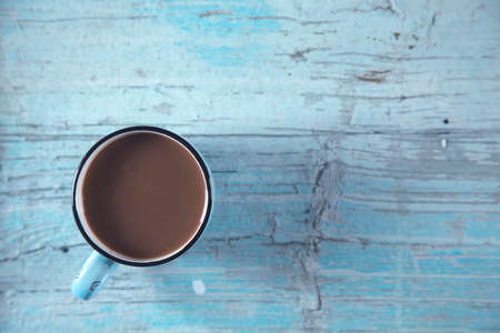 cup of coffee on the wooden table backgroundの写真素材