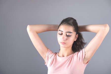 woman tie a tail hair on gray background