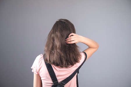 woman hand in hair on gray backgroundの写真素材