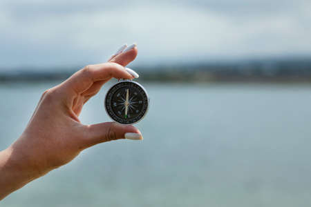 woman hand compass in sea backgroundの写真素材