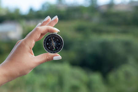 woman hand compass in nature backgroundの写真素材