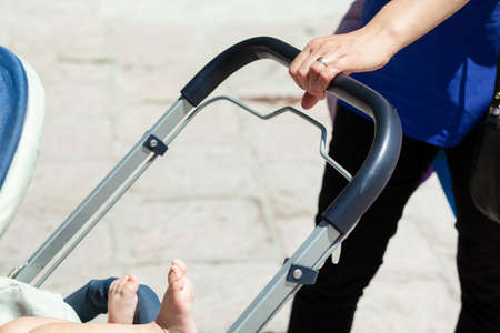 woman and stroller in the street background
