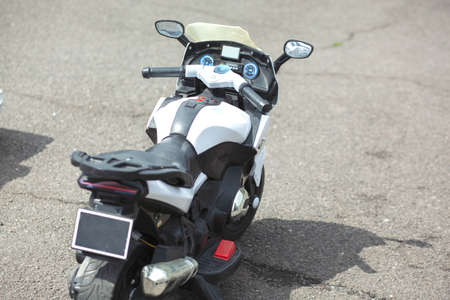 white and small motorcycle in the streetの写真素材