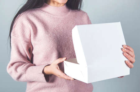 happy young woman hand open white box