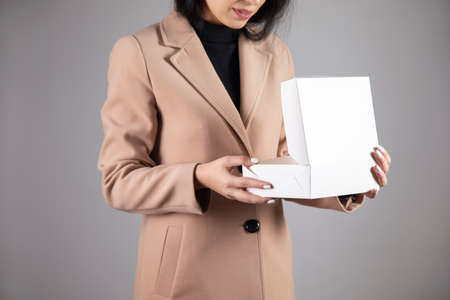 young happy woman holding gift boxの写真素材