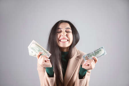 happy young woman holding money