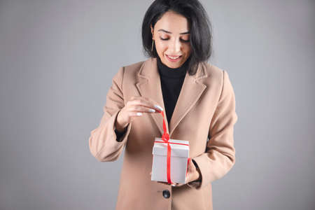young happy woman holding gift boxの写真素材