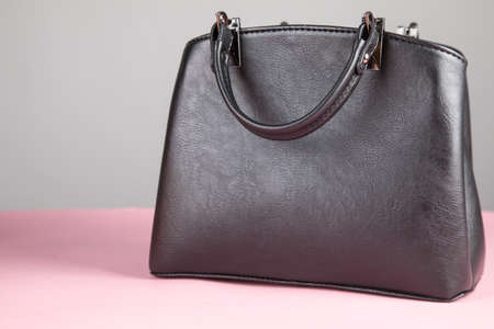 woman black bag on the pink tableの写真素材