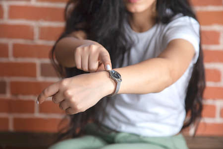 young woman show hand watchの写真素材