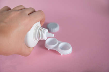 woman hand holding water for optice lensesの写真素材