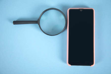 magnifier and phone on the table