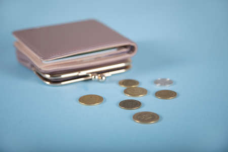 coins and wallet on the blue tableの写真素材
