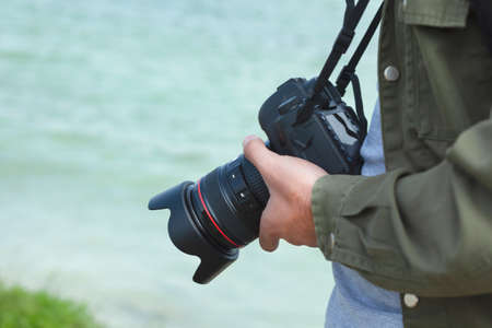 camera in the photographer hand in nature