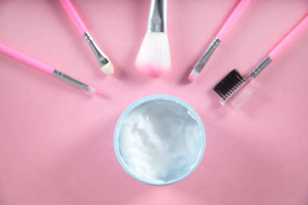 cream for face and brushes on the tableの写真素材