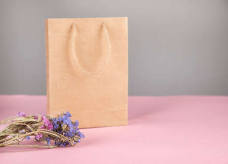 vintage shopping bag with flowers on tableの写真素材