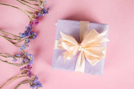Dried color flowers with gift box on table