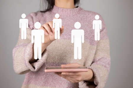 woman holding smart phone with team iconsの写真素材