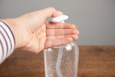 Woman hand sanitizer alcohol gel rub clean handsの写真素材