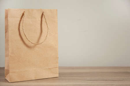 disposable bag of kraft paper on a wooden table