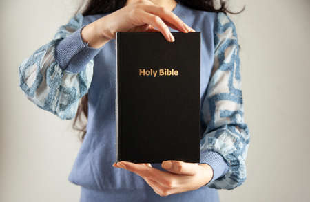 The young prayer woman holding Bible.
