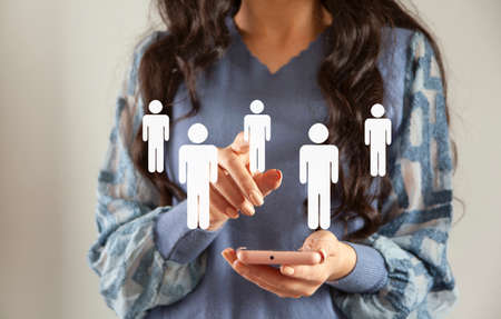 young woman holding phone with people icon