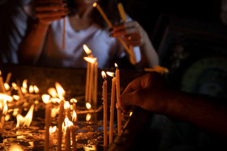 People light candles in the church.