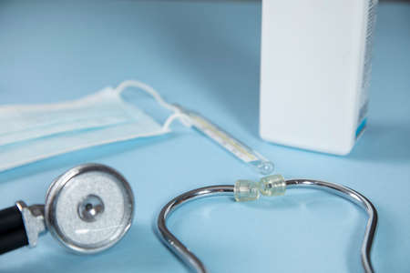 stethoscope with drug and mask on table
