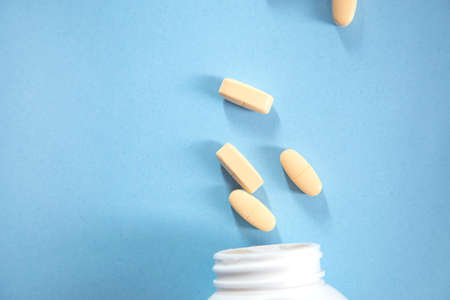 yellow drug on the blue table background