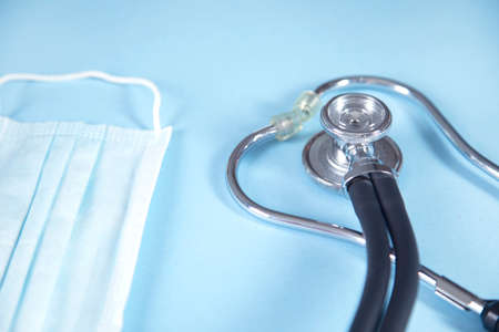 stethoscope and medical mask on the table