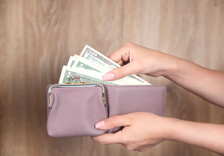 woman holding wallet with the money