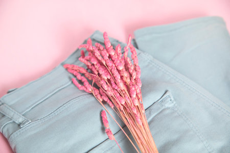 Pink flower on the blue trousers.の写真素材