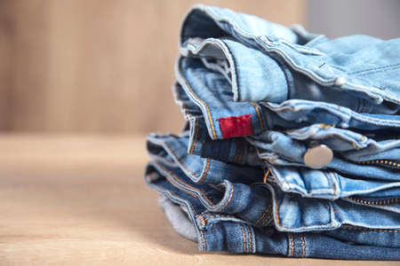 Jeans on the wooden table background.の写真素材