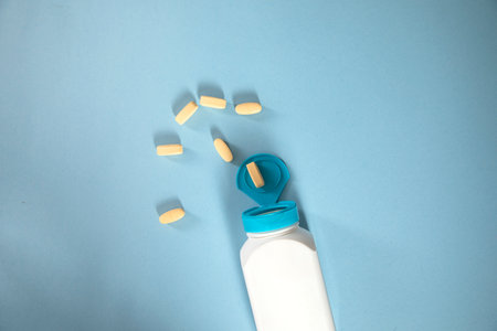 drugs and bottle on the blue table backgroundの写真素材