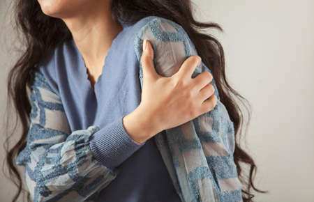 sad young woman hand in ache handの写真素材