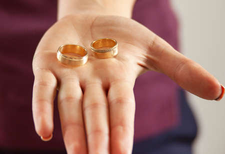 woman hand holding woman and man married ringの写真素材