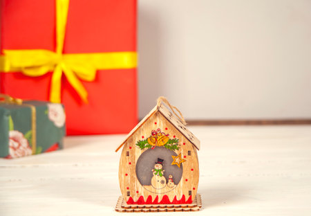 Gift boxes and house model on the wooden table.の写真素材