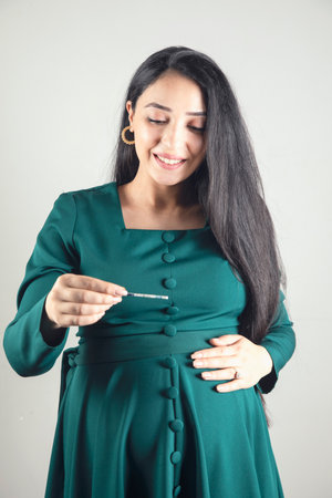 young pregnant woman hand pregnancy test.の写真素材