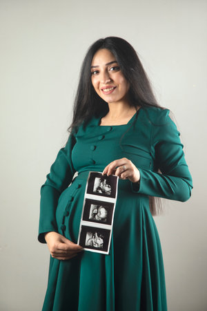 Pregnant woman hand ultrasound picture of baby.の写真素材