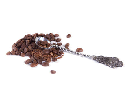 composition of coffee beans and a spoon on a white backgroundの写真素材