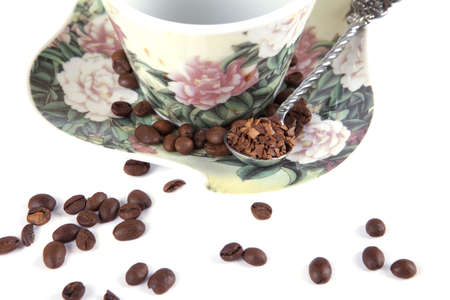composition of coffee beans, cups and spoons on a white backgroundの写真素材