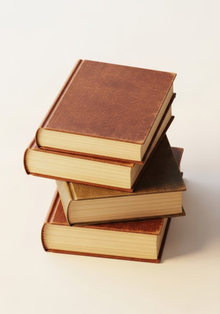 Three leather-bound books are stacked, showcasing textured covers and aged paper edges. The composition highlights the books' vintage aesthetic against a clean, white background.の素材