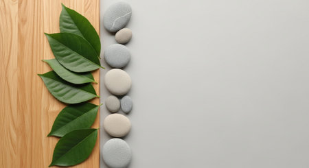 Spa background with zen stones and green leaves on wooden boardの素材