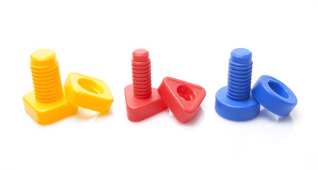 Colourful toy nuts and bolts on white backgroundの写真素材